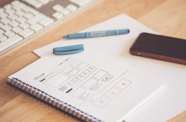 Notepad with website wireframe sketch, representing web design services in Minneapolis